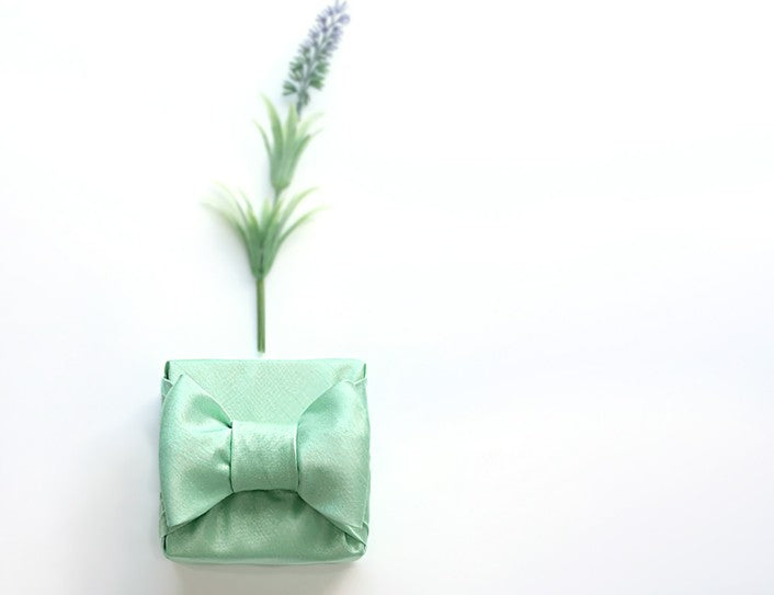 bojagi gift wrap — single-layer — Pastel Green — 50 cm — rosette knot on solid ivory background
